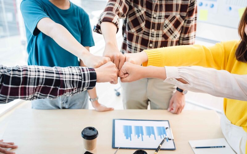 young business people putting their hands together. Stack of hands. Unity and teamwork concept.